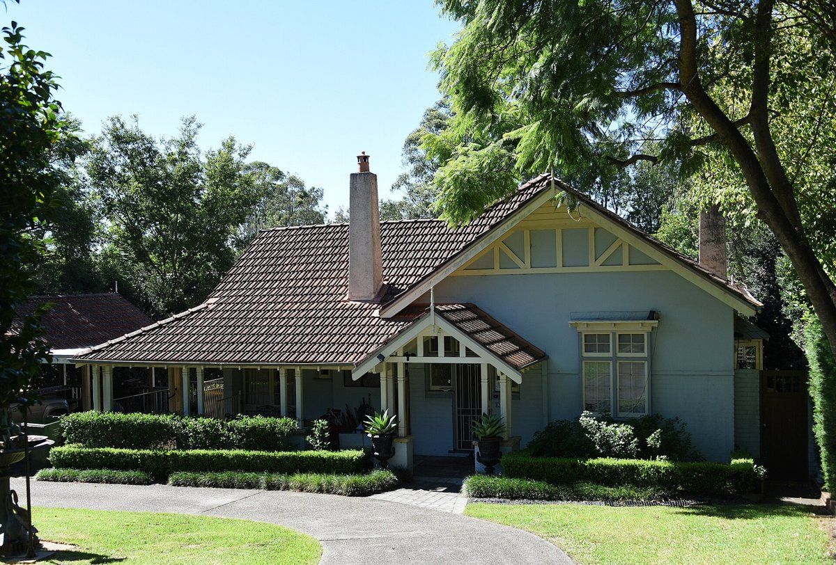 A Federation house in Gordon with a lawn, low hedge and garden bed